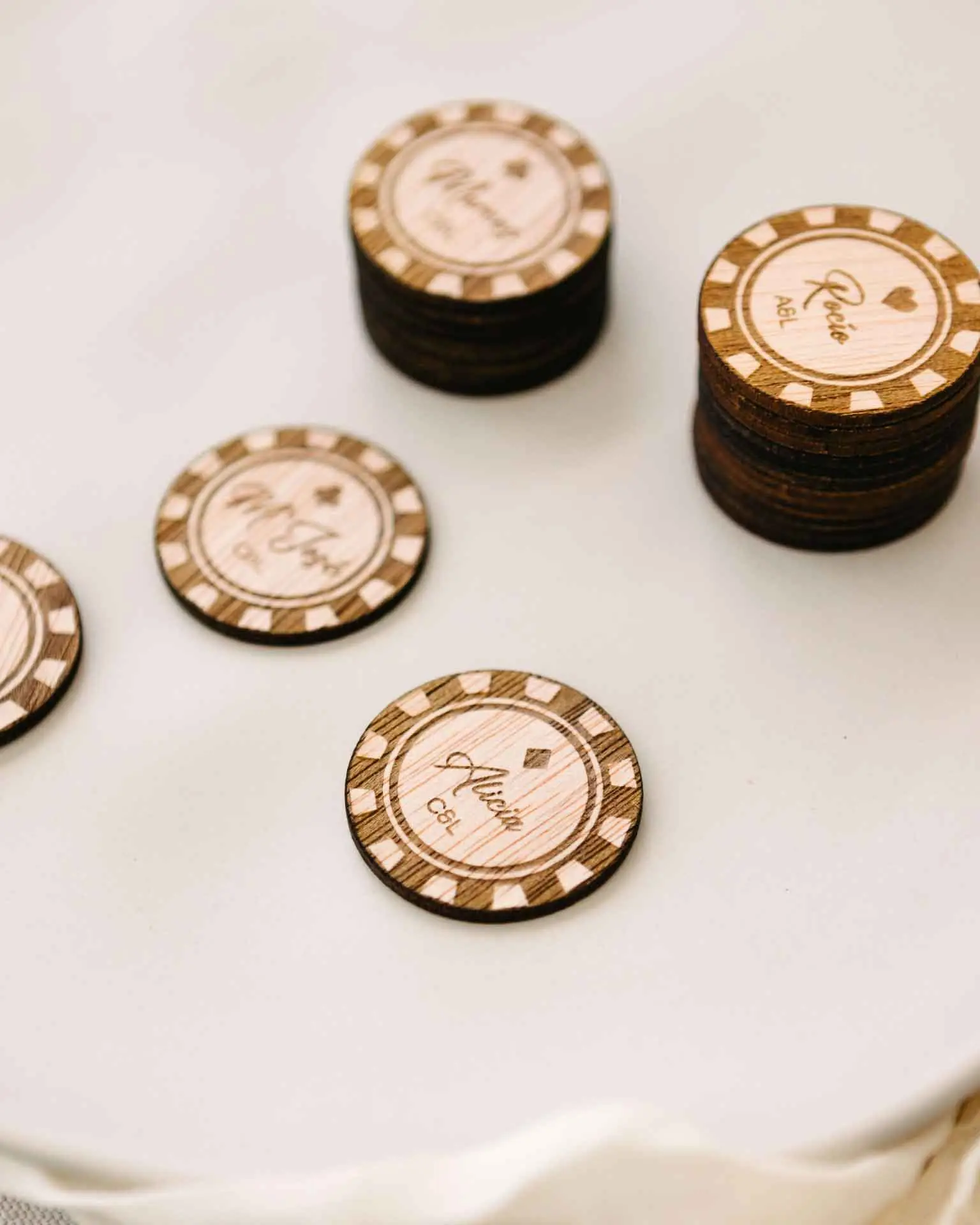 Marcasitios personalizados con forma de ficha de casino y grabado de nombre, con los símbolos clásicos