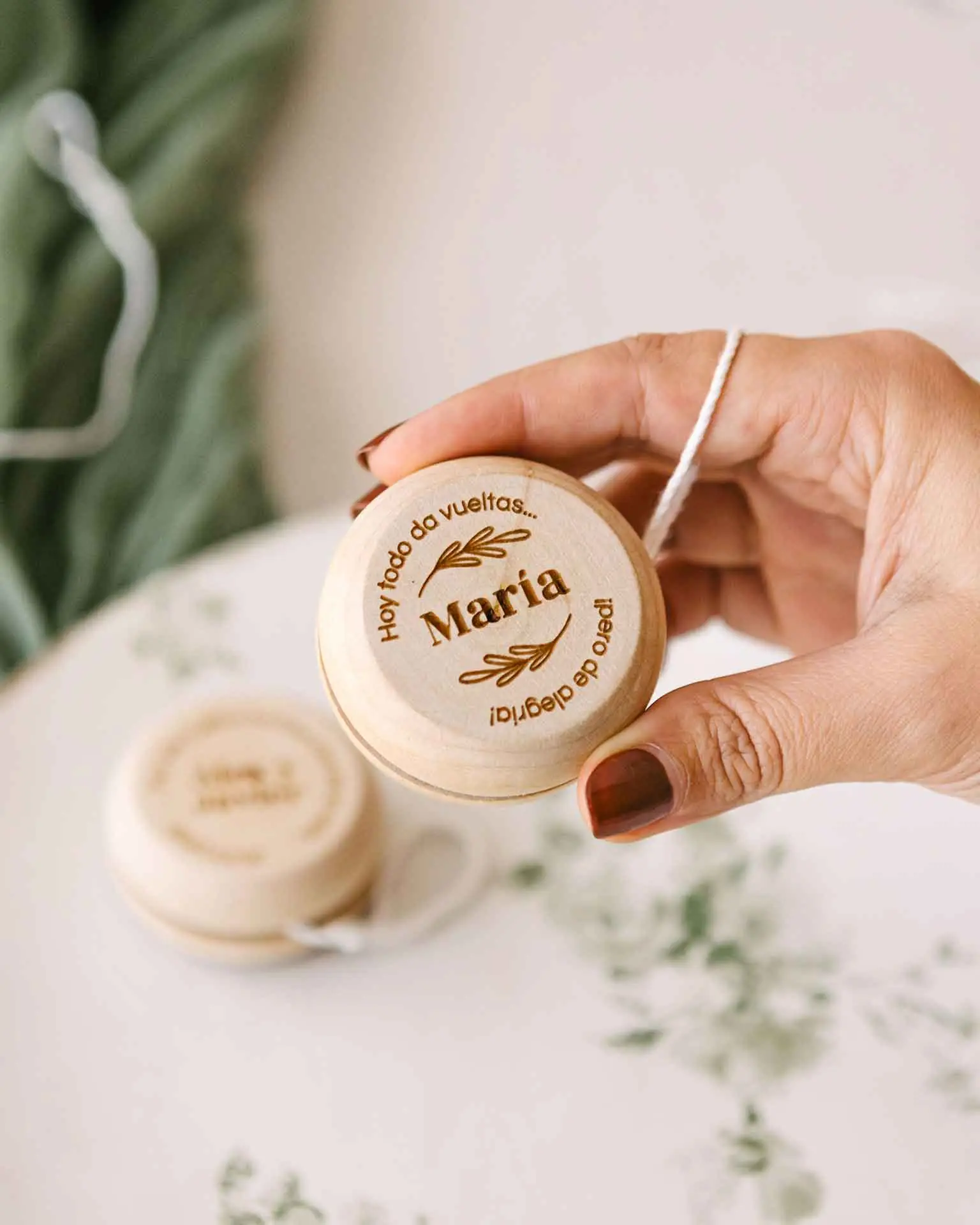 amaño del yoyo personalizado mostrado en la mano, grabado con nombre y diseño decorativo